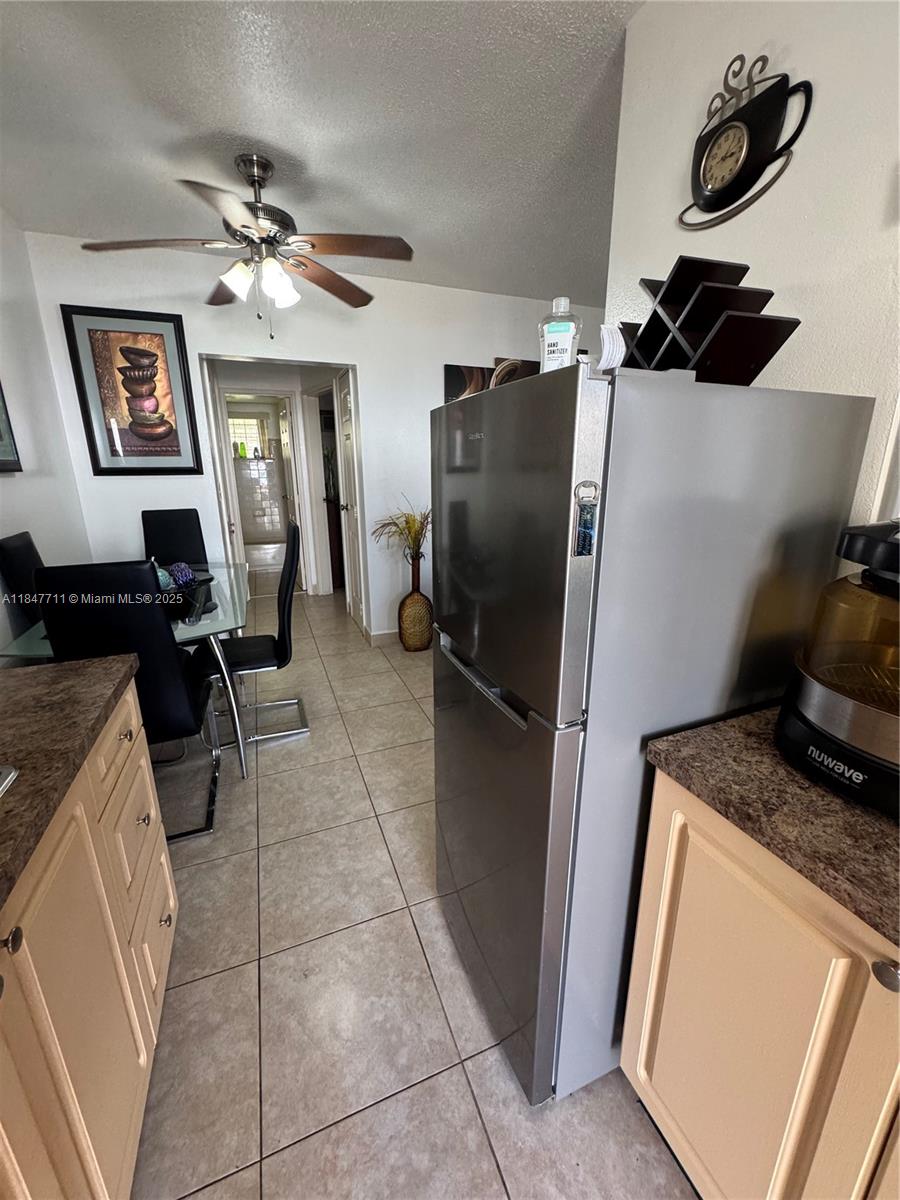 71 Northwest 76th Street, Unit 5 Miami, FL 33150 - Photo 2 of 19 a kitchen with a refrigerator and a stove top oven
