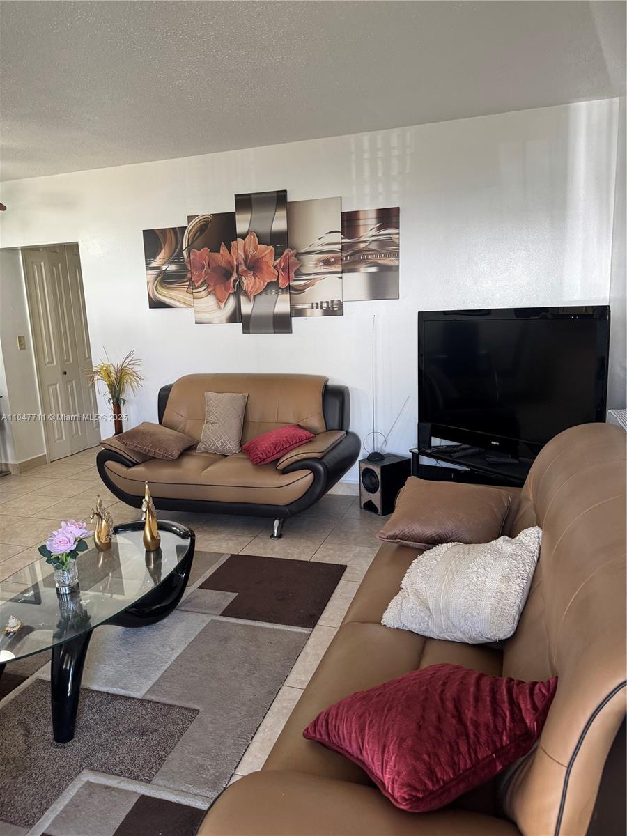 71 Northwest 76th Street, Unit 5 Miami, FL 33150 - Photo 7 of 19 a living room with furniture and a flat screen tv