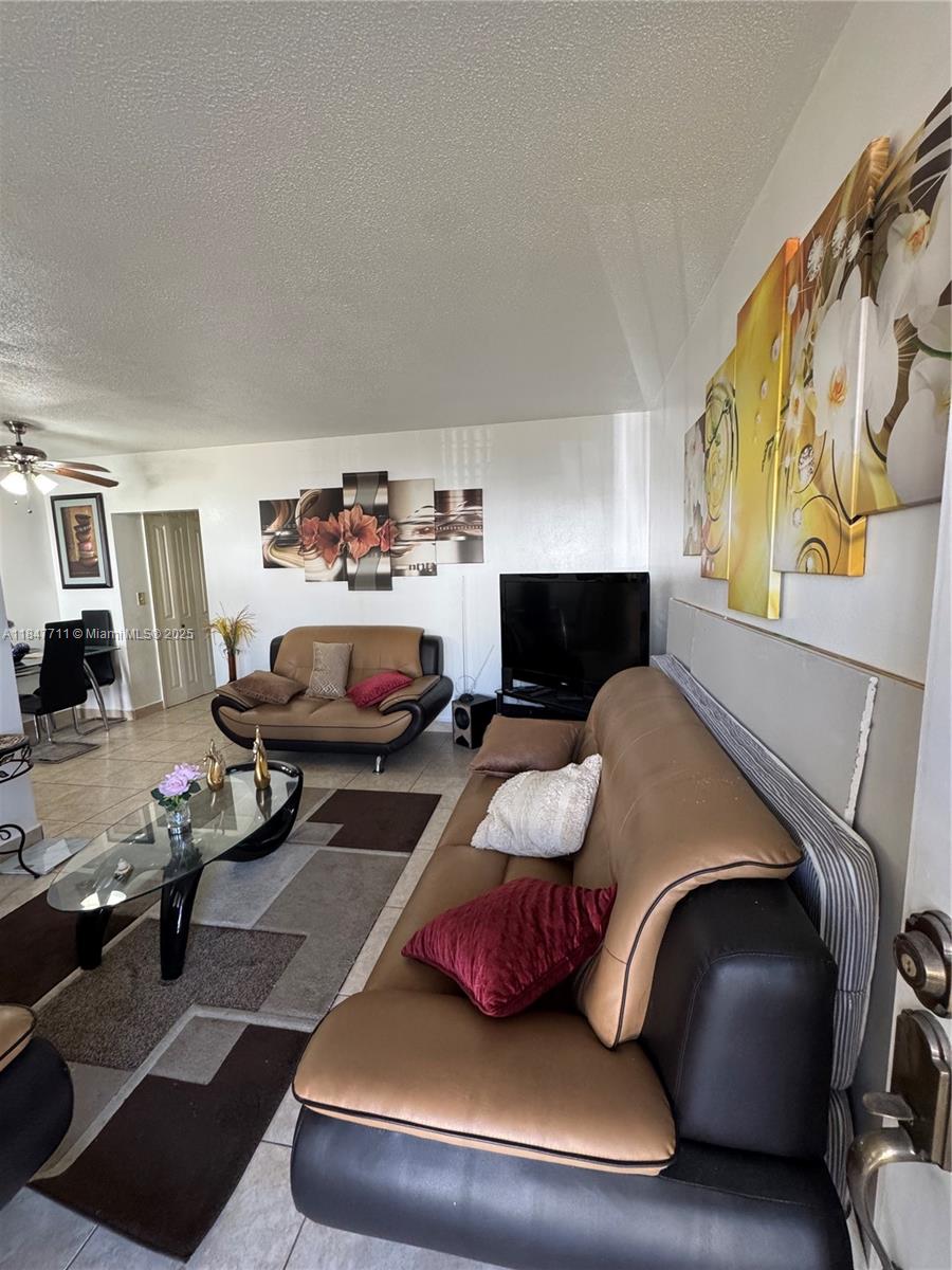 71 Northwest 76th Street, Unit 5 Miami, FL 33150 - Photo 8 of 19 a bedroom with furniture and a fireplace