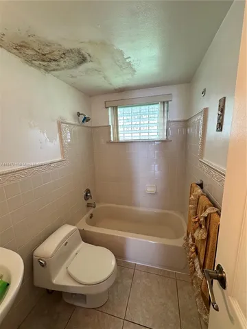 a bathroom with a toilet and a bathtub