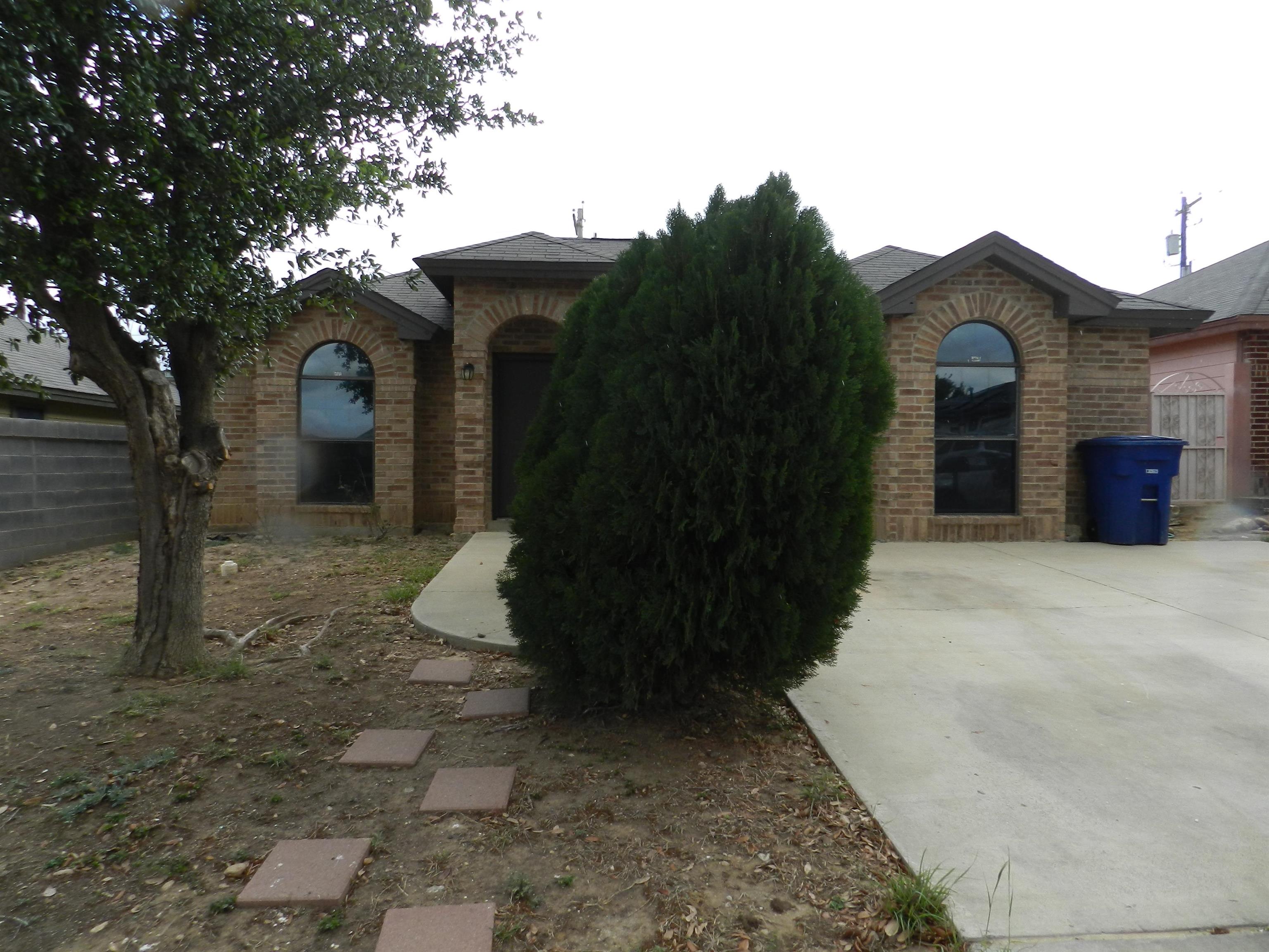 a pathway of a house with a yard