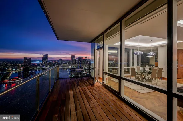 a living room with furniture a lamp and a floor to ceiling window