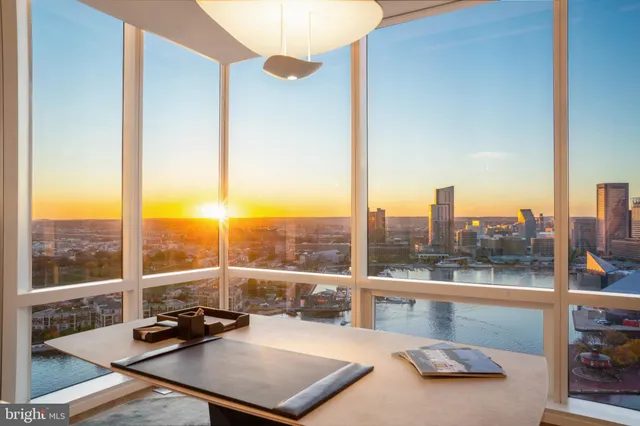 a living room with furniture a chandelier and a large window