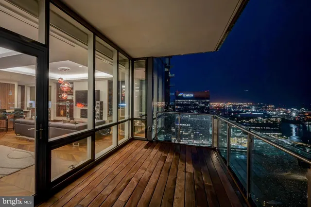 a bedroom with a bed table chair and a potted plant