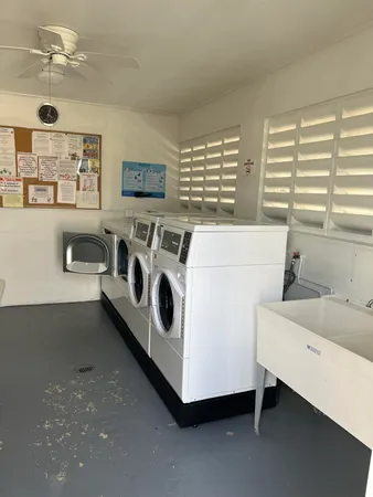 a utility room with multiple dryer and washer