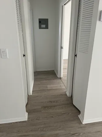 a view of a hallway with wooden floor