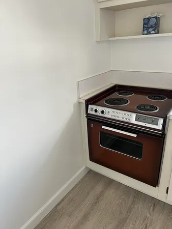 a stove top oven sitting inside of a kitchen