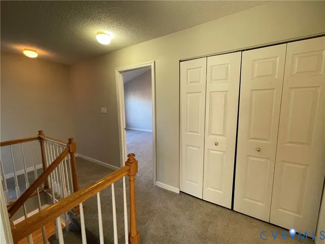 a view of an empty room and closet area