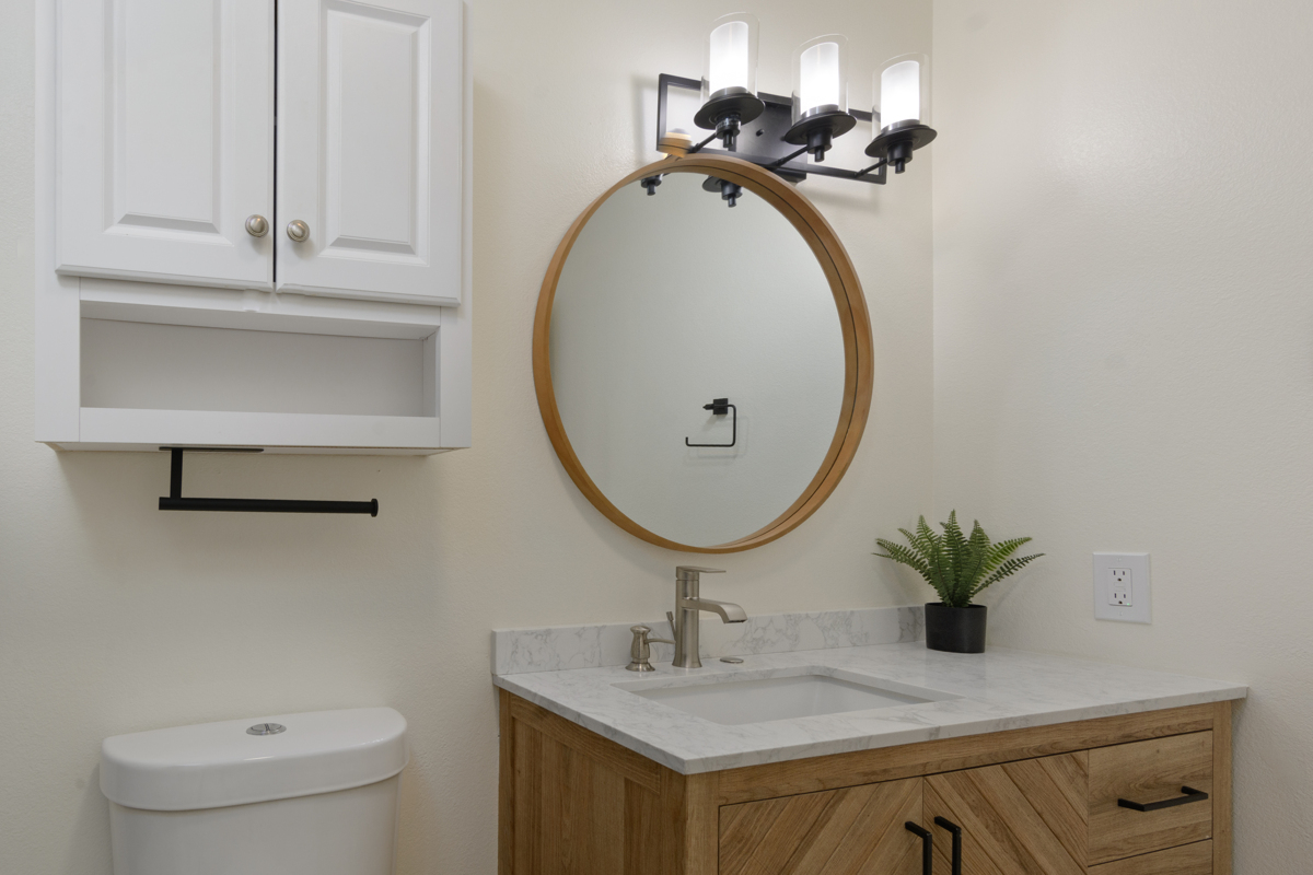 68-3831 Lua Kula Street, Unit G203 Waikoloa, HI 96738 - Photo 8 of 30 a bathroom with a sink a toilet and a mirror