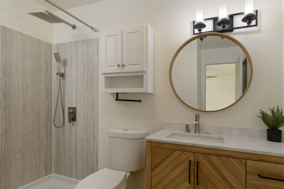 68-3831 Lua Kula Street, Unit G203 Waikoloa, HI 96738 - Photo 9 of 30 a bathroom with a sink a mirror a toilet and a shower