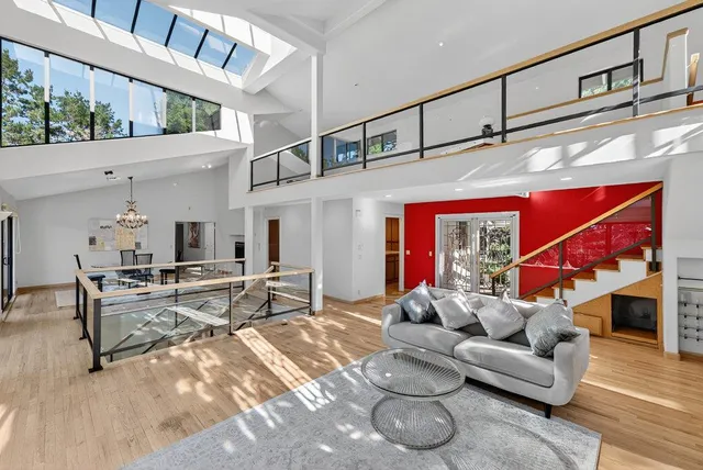 a living room with furniture a chandelier and a flat screen tv