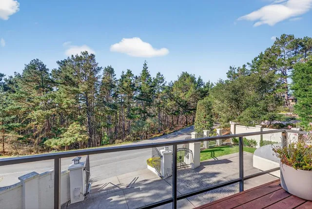 a living room with kitchen island granite countertop furniture a sink a window and stainless steel appliances