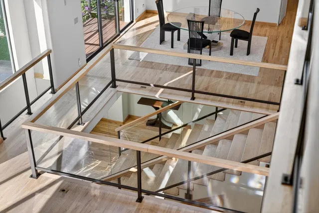 a spacious bedroom with a bed and glass door