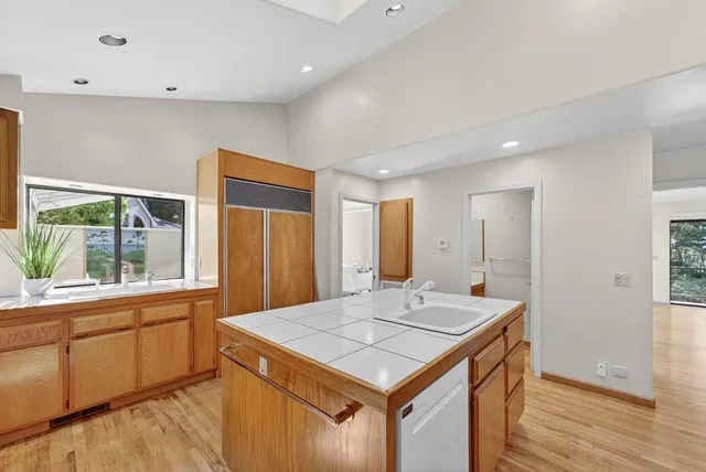 a bathroom with a granite countertop toilet a sink and a mirror