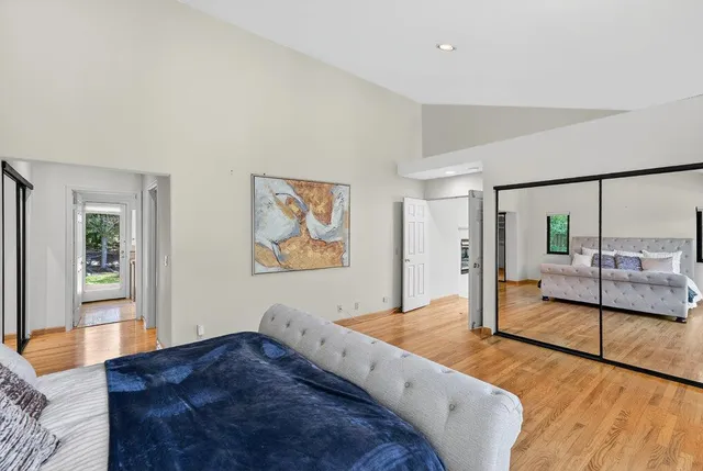 a front view of a house with a yard and potted plants