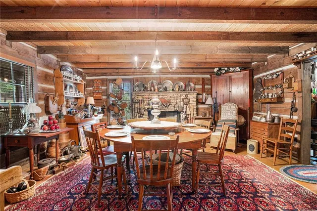 a view of a dining room with furniture and a kitchen