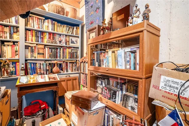 a living room with furniture a flat screen tv and gym equipment