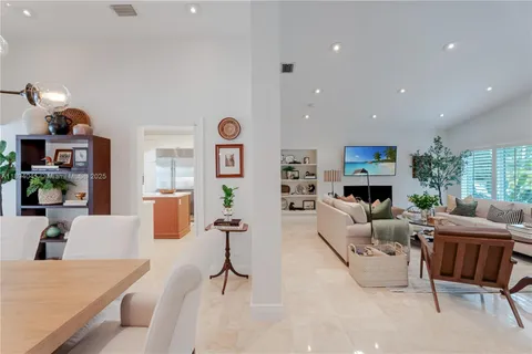 a living room with fireplace furniture and a large window