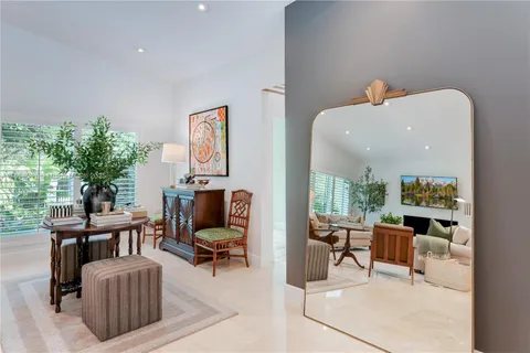 a living room with furniture a fireplace and a potted plant