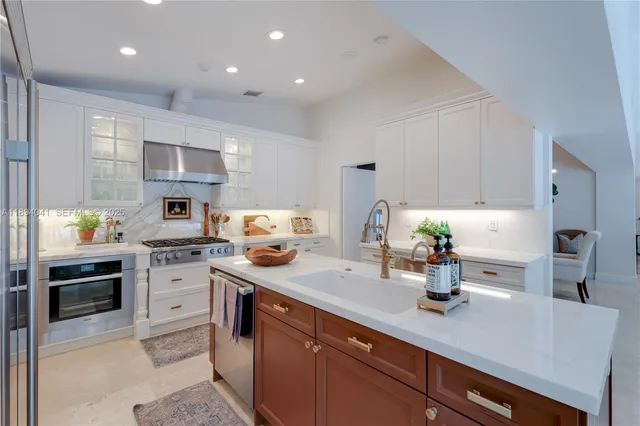 a kitchen with sink a stove and cabinets