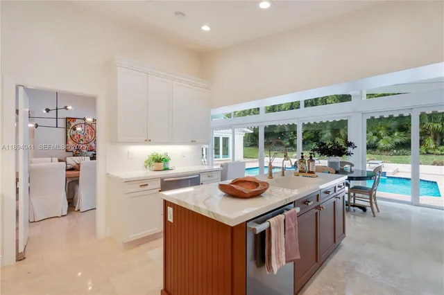 a open kitchen with stainless steel appliances granite countertop a sink and a refrigerator