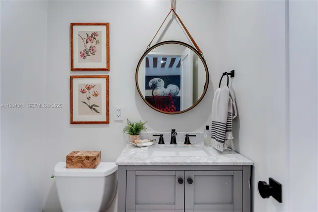 a bathroom with a toilet a sink and a mirror