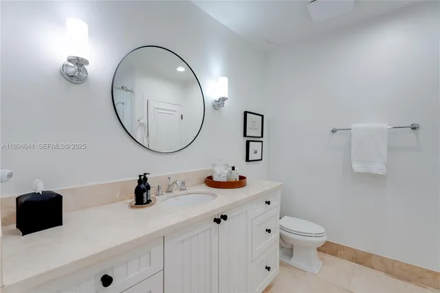 a bedroom with a large bed and a potted plant