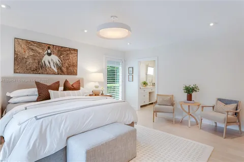a view of a patio with table and chairs potted plants with floor to ceiling window