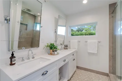 a view of pool with large windows and a yard with plants and large trees