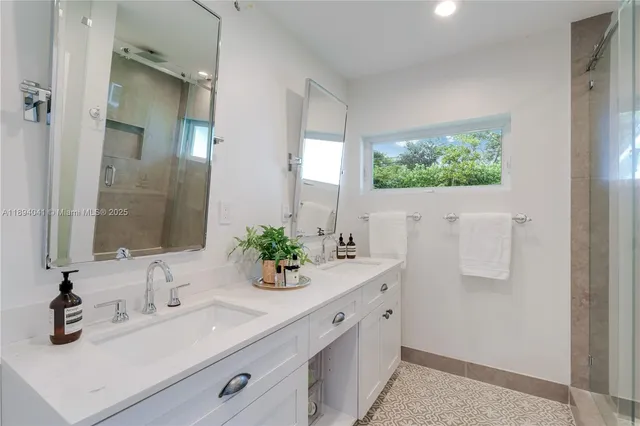 a view of pool with large windows and a yard with plants and large trees