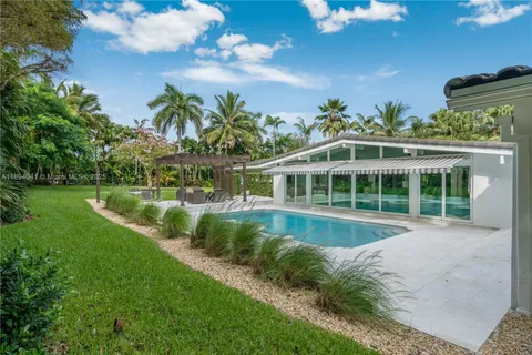an aerial view of a house with a yard
