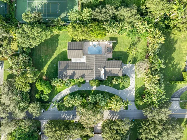 an aerial view of a house with a yard