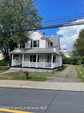 a view of a big house with a outdoor space