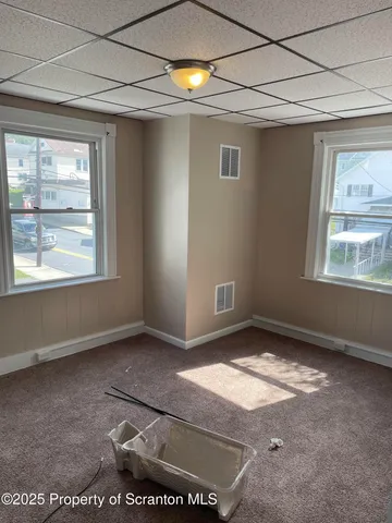 a white toilet sitting next to a bath tub and a shower