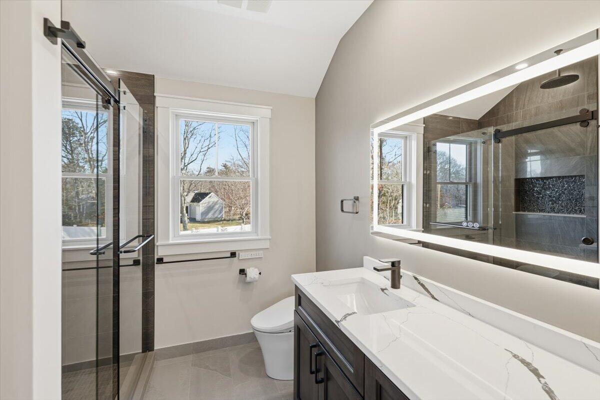 58 Old Chatham Road Brewster, MA 02631 - Photo 21 of 38 a bathroom with a granite countertop sink toilet and a mirror