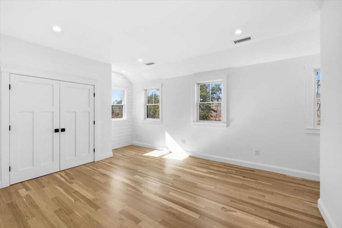 58 Old Chatham Road Brewster, MA 02631 - Photo 26 of 38 a view of empty room with wooden floor and fan