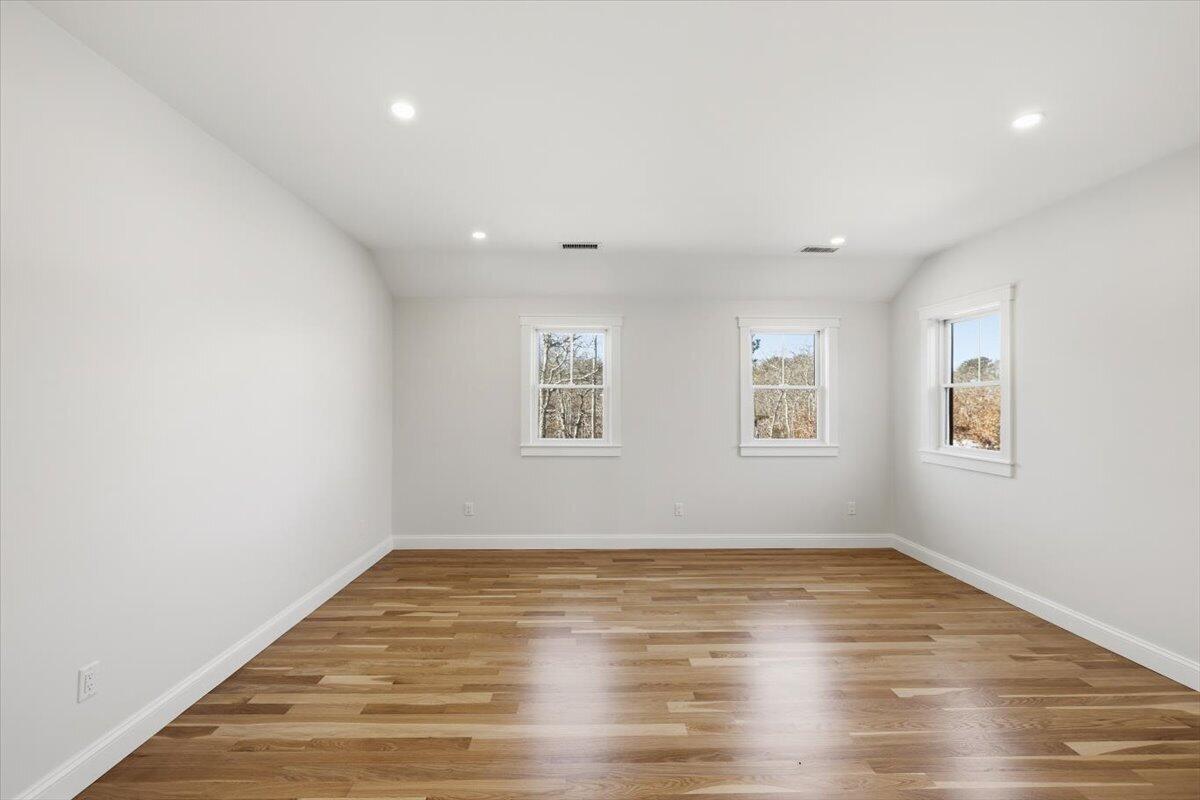 58 Old Chatham Road Brewster, MA 02631 - Photo 28 of 38 an empty room with wooden floor and windows