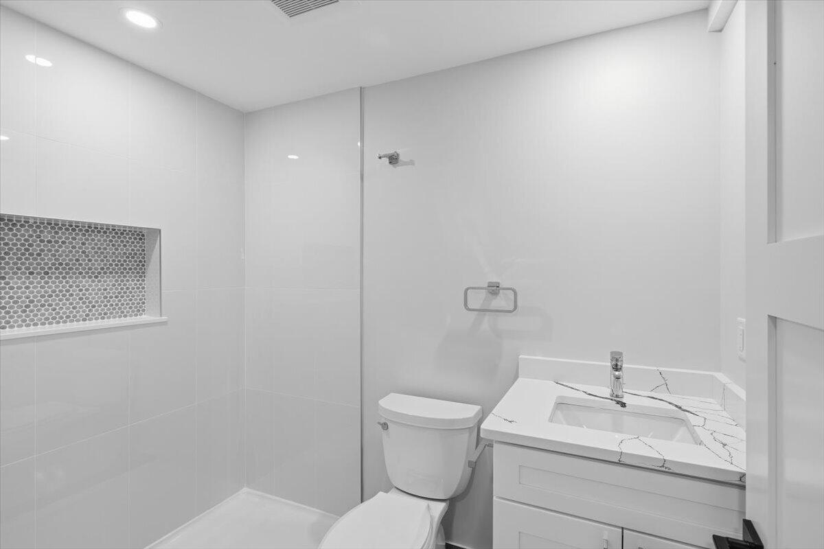 58 Old Chatham Road Brewster, MA 02631 - Photo 31 of 38 a bathroom with a granite countertop sink a toilet and a mirror