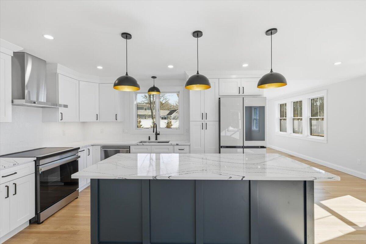 58 Old Chatham Road Brewster, MA 02631 - Photo 6 of 38 a kitchen with living room and stainless steel appliances