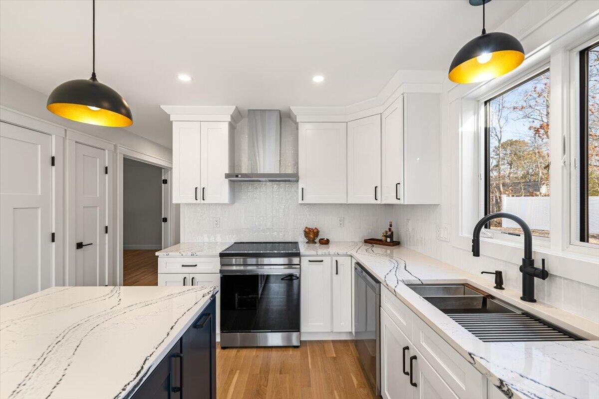 58 Old Chatham Road Brewster, MA 02631 - Photo 7 of 38 a kitchen with a sink a stove and cabinets