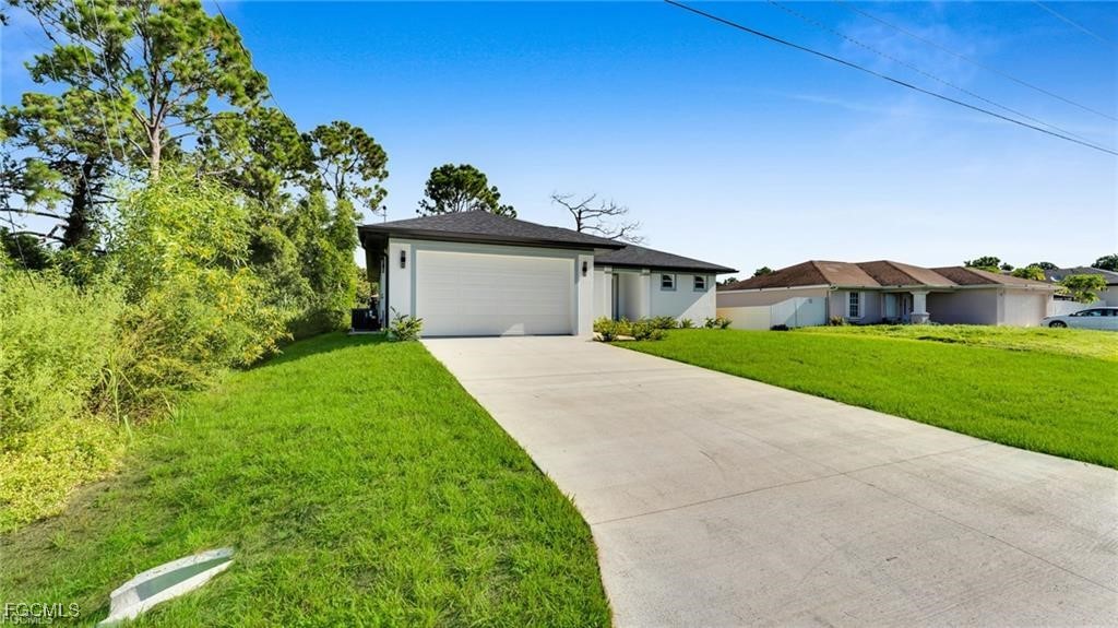 2805 26th Street Southwest Lehigh Acres, FL 33976 - Photo 1 of 27 a front view of house with yard and green space