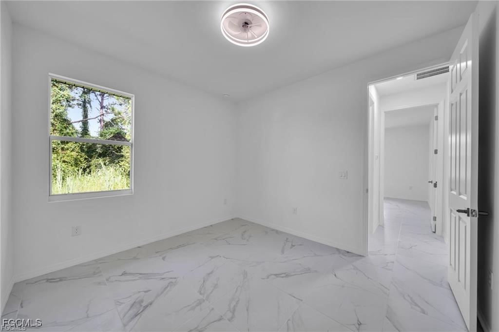 2805 26th Street Southwest Lehigh Acres, FL 33976 - Photo 13 of 27 an empty room with windows