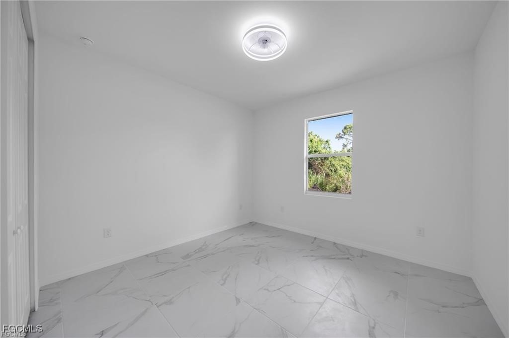 2805 26th Street Southwest Lehigh Acres, FL 33976 - Photo 16 of 27 an empty room with windows