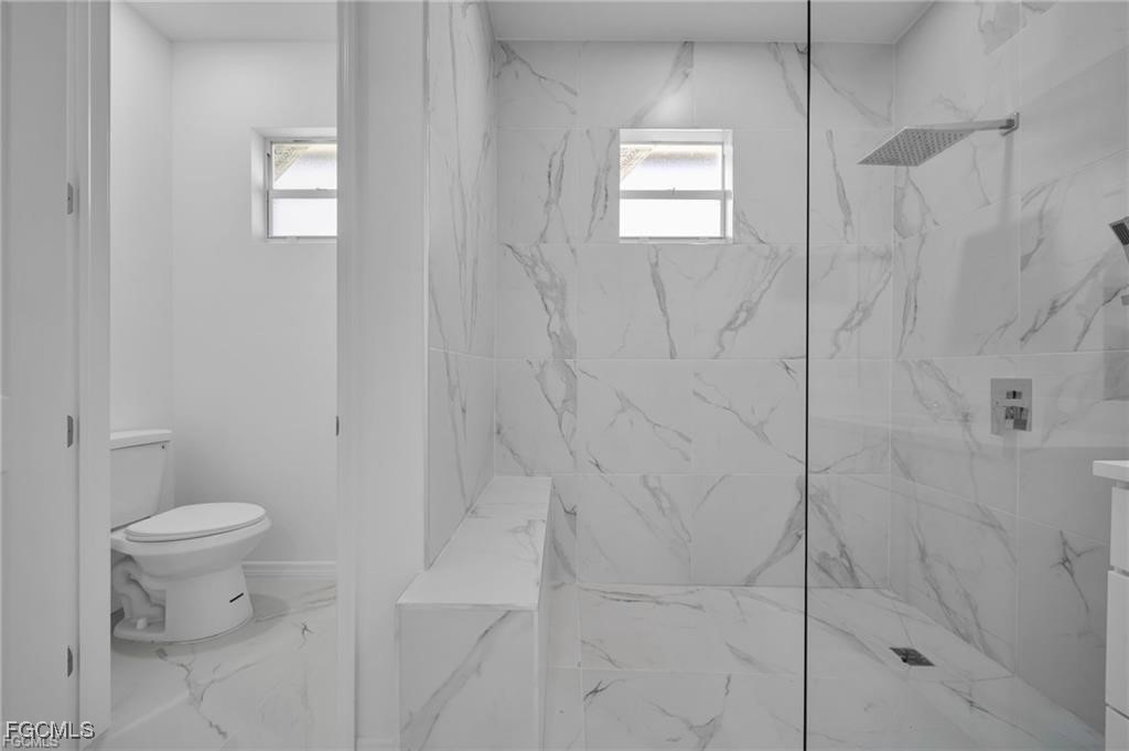 2805 26th Street Southwest Lehigh Acres, FL 33976 - Photo 19 of 27 a bathroom with a toilet and a shower