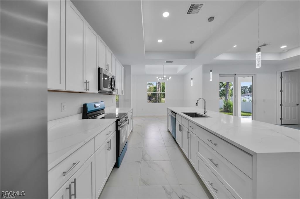 2805 26th Street Southwest Lehigh Acres, FL 33976 - Photo 8 of 27 a large kitchen with stainless steel appliances lots of counter space sink and cabinets