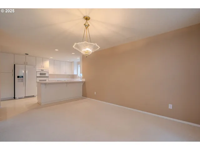 a view of a kitchen with white cabinets