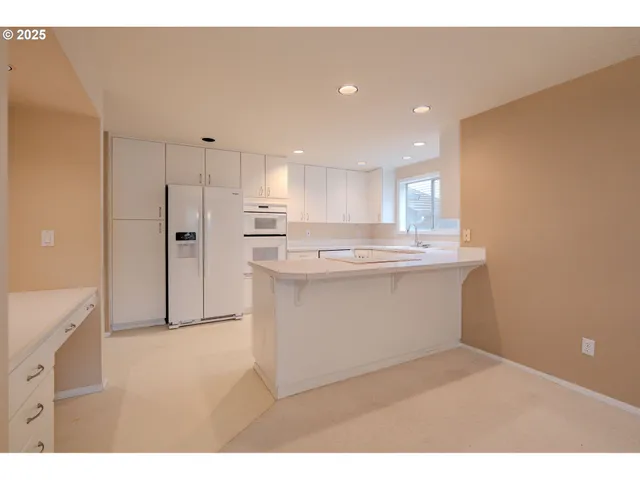 a kitchen with stainless steel appliances a refrigerator sink and cabinets