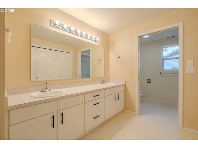 a bathroom with a granite countertop sink mirror and double