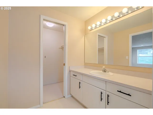 a bathroom with a sink a mirror and a shower