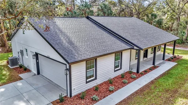 a aerial view of a house with table and chairs